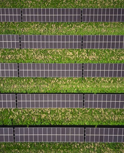 Aerial Drone Shot Of Solar Panels In Field Generating Renewable Sustainable Energy